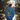 Person wearing a Malibu Blue hoodie with a colourful hjashies psychedelic print design walking through a park