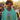 Man wearing a teal hoodie with a colorful design, standing in a crowd.