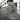 Person wearing a gray hoodie with a colorful graphic and 'HASHIES' text on the back, standing on an urban street.