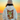 Person wearing a hoodie with a graphic design of a Hashie in a fox onesie rolling around in autumn leaves against a sunset background