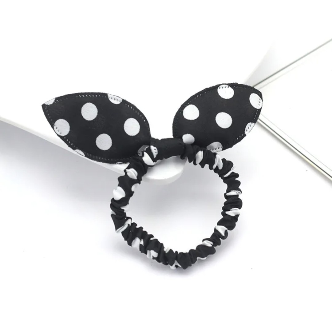 The image features a classic black bunny ear headband with white polka dots, presenting a timeless design for Hashies or as a stylish accessory for desk pets.
