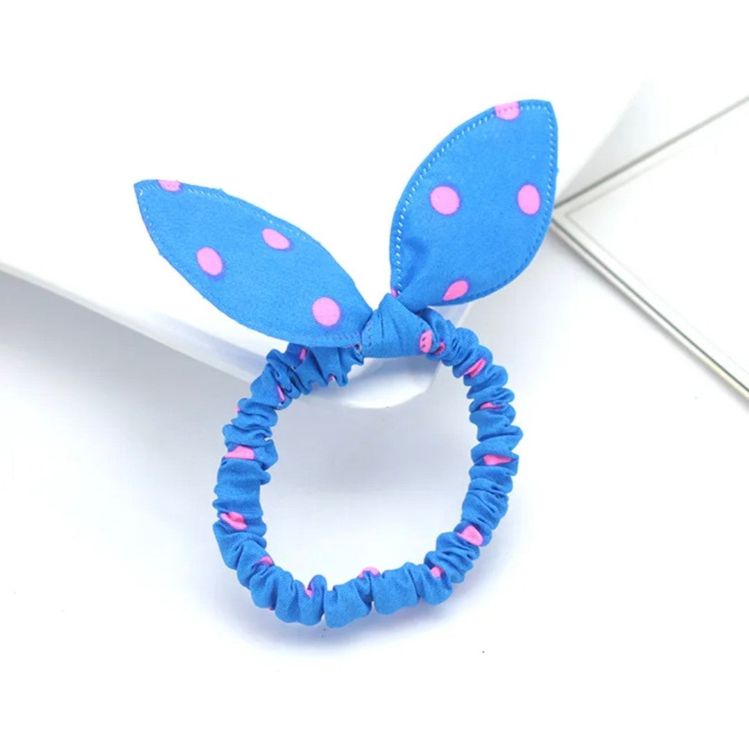 The image showcases a vibrant blue bunny ear headband accented with playful pink polka dots, an ideal accessory for Hashies or as a bright addition to desk pets.