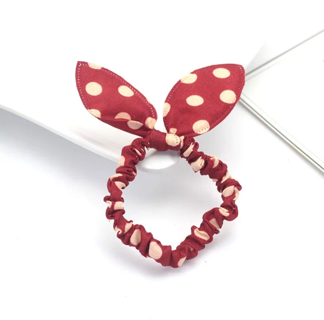 The image illustrates a maroon bunny ear headband speckled with cream polka dots, an accessory that exudes a classic vibe for Hashies or adds an elegant touch to desk pets.