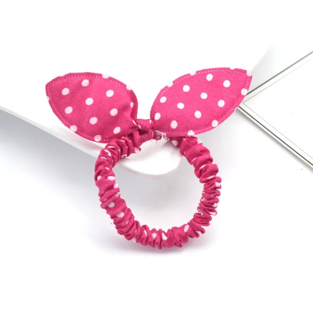 The image captures a playful pink bunny ear headband sprinkled with white polka dots, perfect for adding a splash of fun to Hashies or as a whimsical accessory for desk pets.
