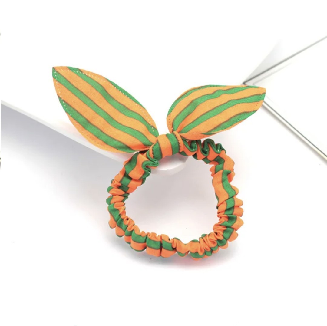 The image displays an orange and green striped bunny ear headband, a vibrant accessory that's perfect for injecting energy into Hashies or as a lively adornment for desk pets.