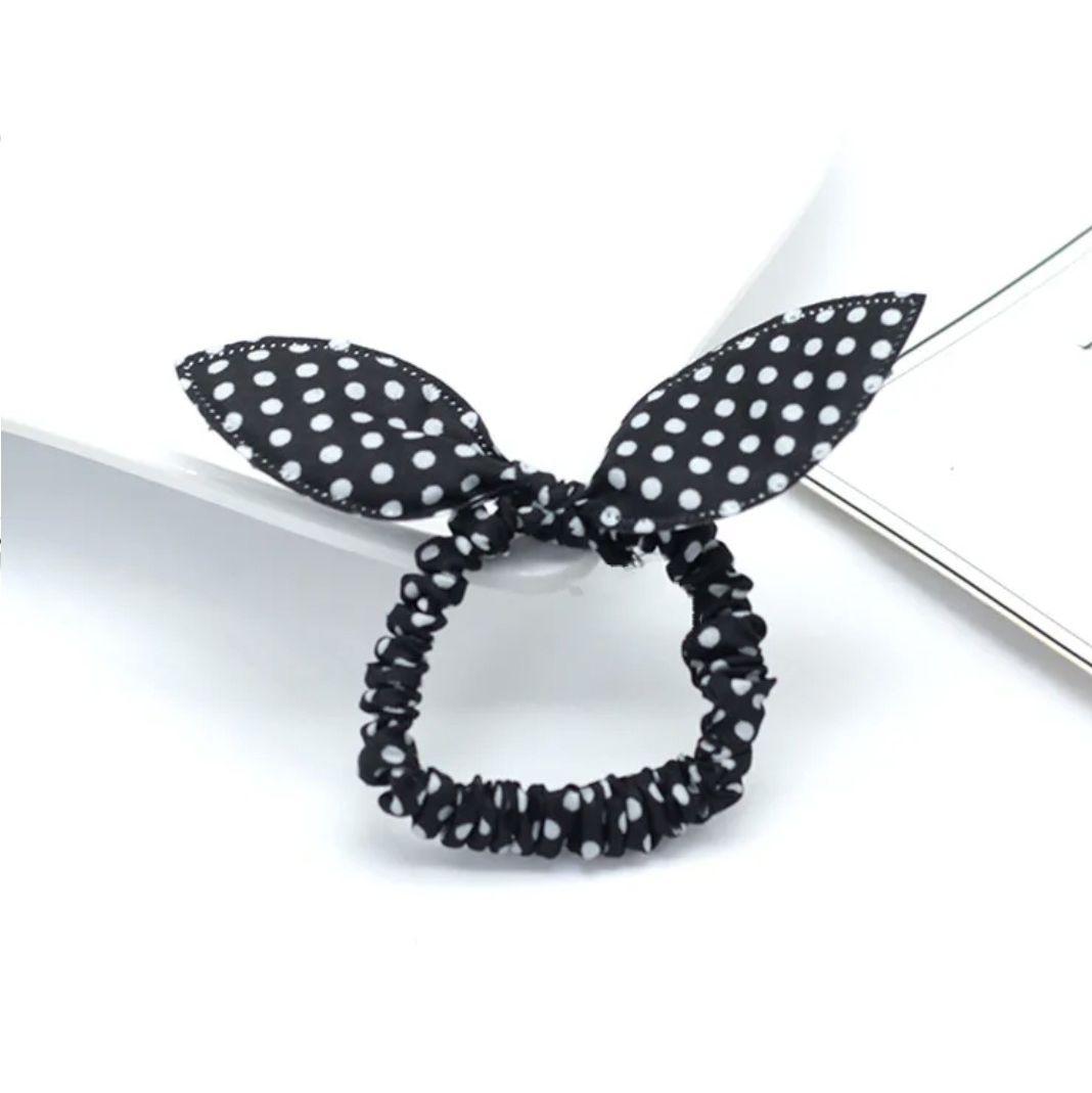 The image depicts a chic black bunny ear headband speckled with white polka dots, a timeless accessory that's stylish for Hashies or as an elegant accent for desk pets.